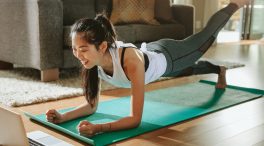 Smiling woman exercising at home